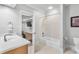 Well-lit bathroom with shower and tub, vanity, toilet, and access to exercise room at 2281 Bransley Pl, Duluth, GA 30097