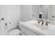 Bathroom featuring a white sink, toilet and hardware, and a framed mirror at 2281 Bransley Pl, Duluth, GA 30097