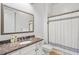 Bathroom featuring a granite countertop, brushed nickel fixtures, and tub-shower combination at 2281 Bransley Pl, Duluth, GA 30097