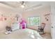 Light-filled bedroom featuring playful wall decals, a pink play tent, and a comfortable rocking chair at 2281 Bransley Pl, Duluth, GA 30097