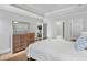 Bedroom with a tray ceiling, featuring a dresser and doors leading to other rooms at 2281 Bransley Pl, Duluth, GA 30097