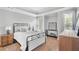Bright bedroom with a white bed, light grey walls, and two windows with blinds at 2281 Bransley Pl, Duluth, GA 30097