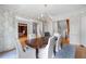 Elegant dining room with wallpaper, hardwood floors, and a chandelier over the dining table at 2281 Bransley Pl, Duluth, GA 30097
