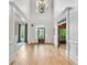 Bright and airy foyer with hardwood floors and elegant trim, leading to other rooms at 2281 Bransley Pl, Duluth, GA 30097
