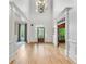 Bright entryway with hardwood floors and white molding, leading to various rooms in the house at 2281 Bransley Pl, Duluth, GA 30097
