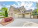 Spacious three-car garage with a brick exterior, complemented by well-maintained landscaping and a winding driveway at 2281 Bransley Pl, Duluth, GA 30097