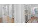 Hallway featuring a beverage cooler and convenient access to a powder room and mudroom at 2281 Bransley Pl, Duluth, GA 30097