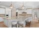 Spacious kitchen featuring white cabinets, granite countertops, and a large center island with seating at 2281 Bransley Pl, Duluth, GA 30097