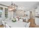 A view from the dining room to the open concept kitchen and living space with white cabinets and hardwood flooring at 2281 Bransley Pl, Duluth, GA 30097