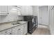 Bright laundry room with modern appliances, cabinetry, and tiled floor at 2281 Bransley Pl, Duluth, GA 30097