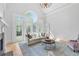 Bright living room featuring a fireplace, hardwood floors, and large windows overlooking the yard at 2281 Bransley Pl, Duluth, GA 30097