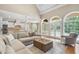 Open-concept living room and kitchen with high ceilings, large windows, and modern finishes at 2281 Bransley Pl, Duluth, GA 30097