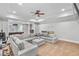 Spacious living room featuring a gray sectional sofa with a ceiling fan and recessed lights at 2281 Bransley Pl, Duluth, GA 30097