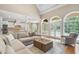 Open concept living room and kitchen with large windows, hardwood floors, and neutral tones at 2281 Bransley Pl, Duluth, GA 30097