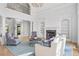 Spacious living room with a fireplace, built-in shelving, and hardwood floors, bathed in natural light at 2281 Bransley Pl, Duluth, GA 30097