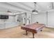 Living room with gray sectional sofa, and adjacent recreation area with pool table at 2281 Bransley Pl, Duluth, GA 30097
