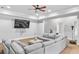 Spacious living room featuring neutral paint, carpeted floors, ceiling fan, and large sectional couch at 2281 Bransley Pl, Duluth, GA 30097
