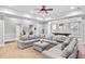 Spacious living room featuring neutral paint, carpeted floors, coffered ceiling, and a large sectional couch at 2281 Bransley Pl, Duluth, GA 30097