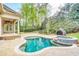 A stunning backyard pool with a relaxing spa, surrounded by lush landscaping, offers a private outdoor oasis at 2281 Bransley Pl, Duluth, GA 30097