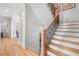 Staircase with hardwood steps and wrought iron railing, leading to the upper level of the home at 2281 Bransley Pl, Duluth, GA 30097