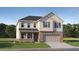 Charming two-story home with brick and siding, a covered entry, and an attached two-car garage at 236 Paisley Way, Locust Grove, GA 30248