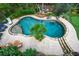 Aerial view of kidney shaped pool, putting green, outdoor seating and lush landscaping at 4688 Oakleigh Manor Dr, Powder Springs, GA 30127