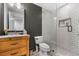 Stylish bathroom with a glass shower, subway tile, and a wood vanity at 4688 Oakleigh Manor Dr, Powder Springs, GA 30127