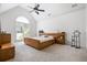A bedroom with vaulted ceilings, cozy carpet, a ceiling fan and bright windows at 4688 Oakleigh Manor Dr, Powder Springs, GA 30127