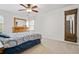 Bedroom featuring a cozy bed, matching wooden dresser, and a full-length mirror, creating a relaxing and functional space at 4688 Oakleigh Manor Dr, Powder Springs, GA 30127