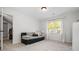 Well-lit bedroom features a comfortable daybed, a large window with blinds, and soft carpet, ideal for relaxation at 4688 Oakleigh Manor Dr, Powder Springs, GA 30127