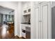 Convenient coffee bar area featuring built-in cabinets, sink, and an under-counter refrigerator at 4688 Oakleigh Manor Dr, Powder Springs, GA 30127