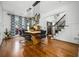 Elegant dining room featuring hardwood floors, stylish lighting, and ample space for entertaining guests at 4688 Oakleigh Manor Dr, Powder Springs, GA 30127
