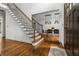 Elegant foyer with hardwood floors, staircase with iron railings, and an open view to the dining room at 4688 Oakleigh Manor Dr, Powder Springs, GA 30127