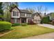 Charming two-story home featuring manicured lawn, brick accents, and an attached two-car garage at 4688 Oakleigh Manor Dr, Powder Springs, GA 30127