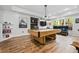 Bright game room with a wooden pool table, recessed lights, and decorative artwork at 4688 Oakleigh Manor Dr, Powder Springs, GA 30127
