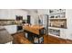 Modern kitchen with stainless steel appliances, custom island, and sleek white cabinetry, perfect for entertaining at 4688 Oakleigh Manor Dr, Powder Springs, GA 30127