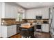 A kitchen with updated stainless steel appliances, stylish cabinetry, and a versatile island at 4688 Oakleigh Manor Dr, Powder Springs, GA 30127
