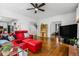 Spacious living area with seamless flow to the adjacent kitchen and featuring hardwood floors at 4688 Oakleigh Manor Dr, Powder Springs, GA 30127