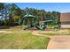 A green playground area features multiple slides and play stations for community children to enjoy at 4688 Oakleigh Manor Dr, Powder Springs, GA 30127