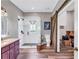 An updated bathroom featuring a shower, stained glass window and a sliding barn door to a storage area at 6585 Queen Mill Se Rd, Mableton, GA 30126