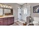 Updated bathroom with a glass shower enclosure, vanity with lots of storage space, and stained glass window at 6585 Queen Mill Se Rd, Mableton, GA 30126