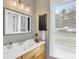 This light and airy bathroom features a large mirror and natural light from a large window at 6585 Queen Mill Se Rd, Mableton, GA 30126