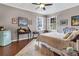 This is a bright and cozy bedroom with wood floors, two large windows, and interesting aviation themed decor at 6585 Queen Mill Se Rd, Mableton, GA 30126