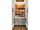 Stylish coffee bar with wood plank wall, decorative shelving, and modern fixtures offers a charming space for beverage preparation at 6585 Queen Mill Se Rd, Mableton, GA 30126