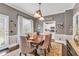 Well-appointed dining room with modern lighting, neutral paint, and access to the kitchen at 6585 Queen Mill Se Rd, Mableton, GA 30126