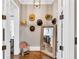 Charming entryway with hat decorations and a large mirror offers a stylish and welcoming first impression of the home at 6585 Queen Mill Se Rd, Mableton, GA 30126