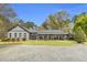 Inviting single-story home featuring a cozy front porch, well-maintained lawn, and mature landscaping at 6585 Queen Mill Se Rd, Mableton, GA 30126