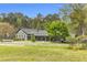 Beautiful single-story home with mature trees in a sprawling manicured front yard at 6585 Queen Mill Se Rd, Mableton, GA 30126