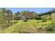 Exterior home view features a charming pond, green lawn, and cozy bench seating area at 6585 Queen Mill Se Rd, Mableton, GA 30126