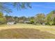 Expansive exterior with a home, lots of green space, outbuildings, and mature trees at 6585 Queen Mill Se Rd, Mableton, GA 30126